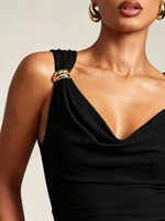 Black one-shoulder dress with gold accents worn by a model against a neutral background