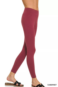 Maroon leggings worn by a person on a white background