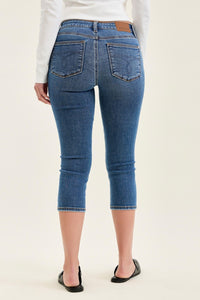 Blue jeans worn by a person on a white background