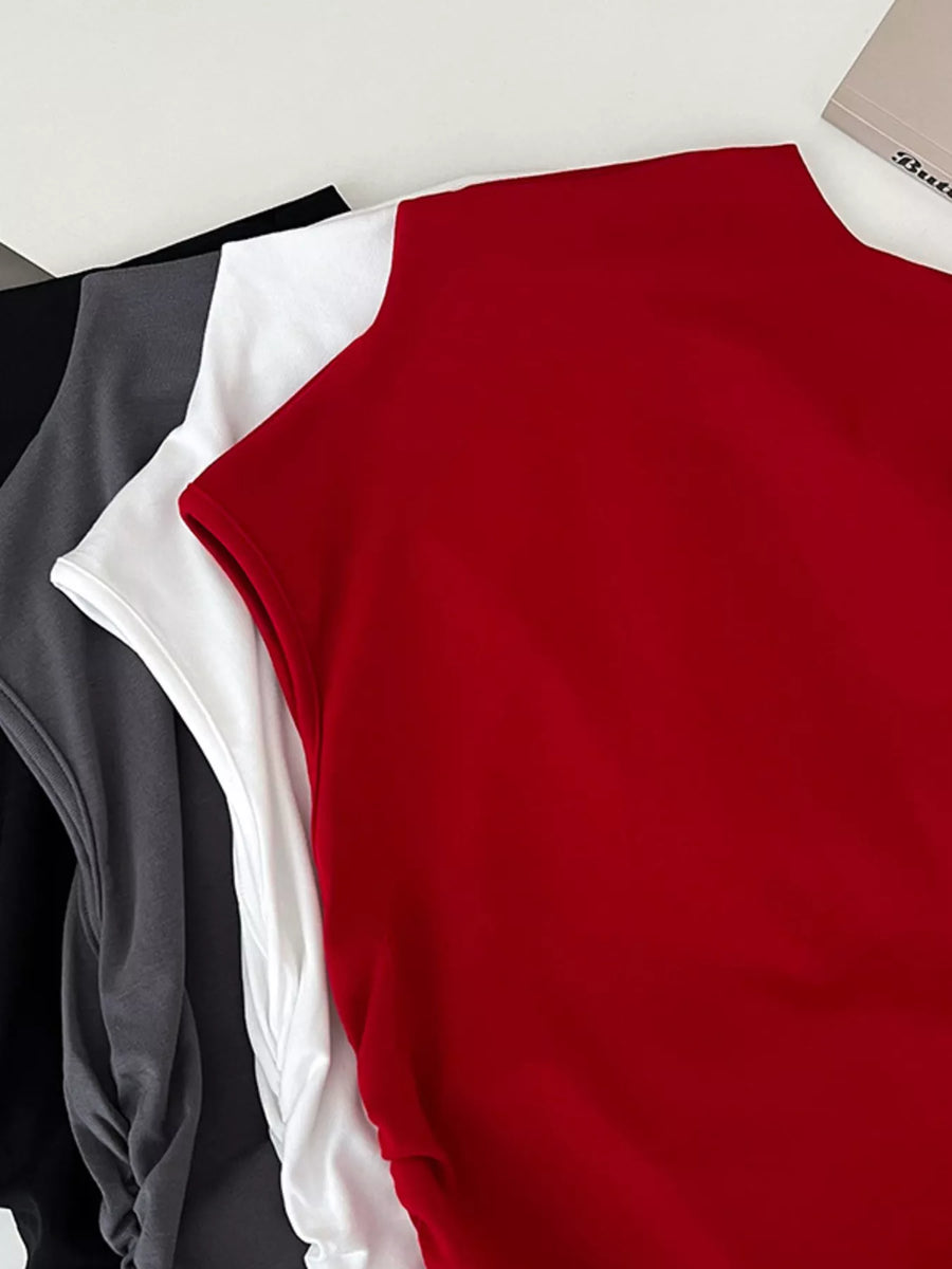 Red, white, and black sleeveless top on a light gray background