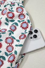Floral-patterned fabric with a smartphone on a light background