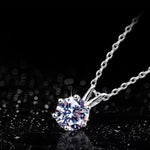 Silver necklace with a diamond pendant on a black background