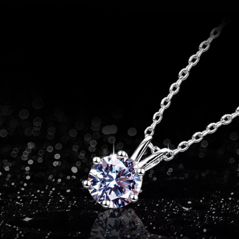 Silver necklace with a diamond pendant on a black background