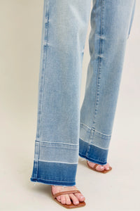 Close-up of light blue jeans on a plain background
