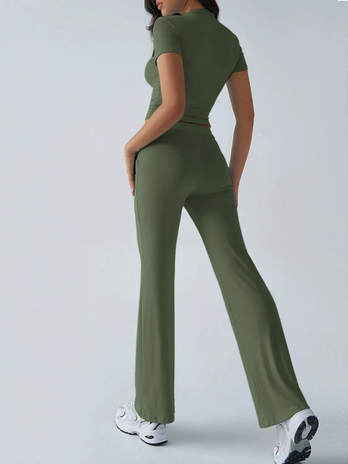 Person wearing a green jumpsuit on a white background