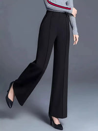 Black wide-leg pants worn by a person on a gray background