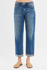 Blue jeans with rolled-up cuffs on a white background