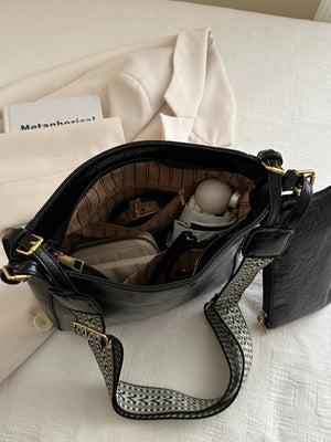 A view of inside of black PU Leather Adjustable Strap Crossbody Bag with Pouch