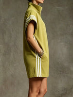 Green dress with white stripes on a textured gray background