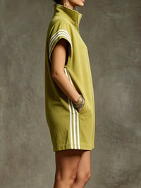 Green dress with white stripes on a textured gray background