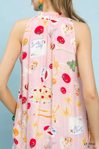 Light pink sleeveless dress with colorful fruit and cake pattern on a light blue background