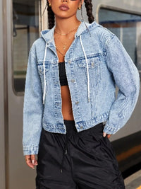 Person wearing a light blue denim jacket with a blurred background