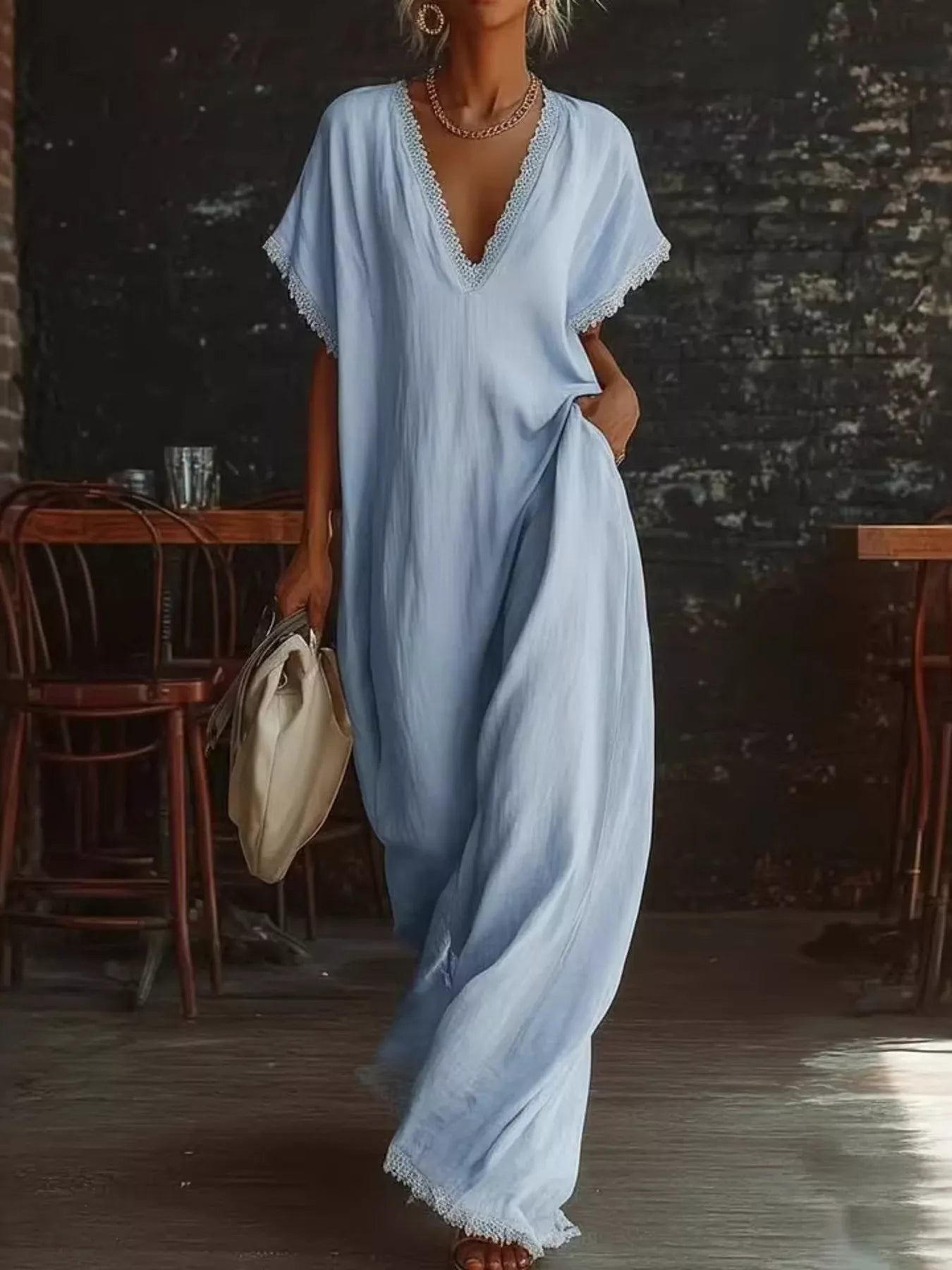 Woman wearing a light blue dress in a rustic indoor setting