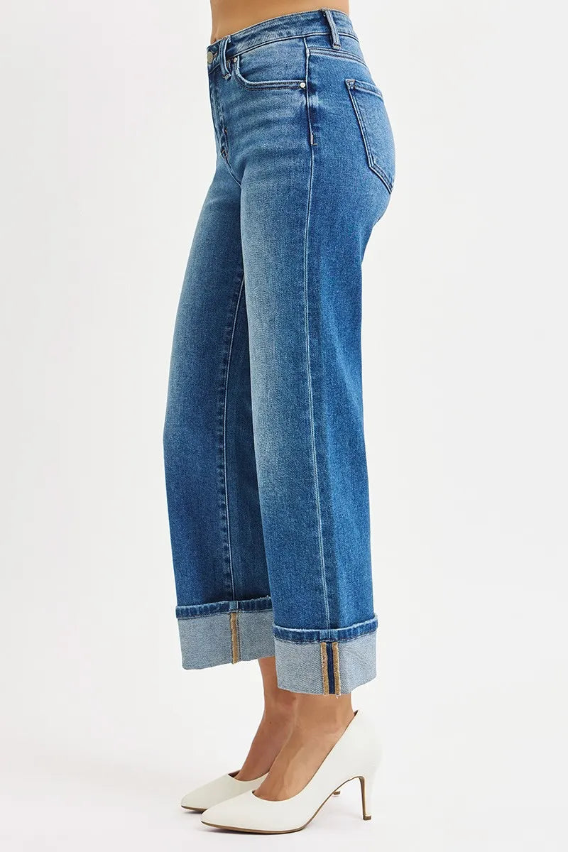Blue jeans with rolled-up cuffs on a white background