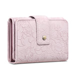 Pink floral embossed wallet with a gold clasp on a white background
