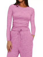 Pink long-sleeve top and pants set on a white background