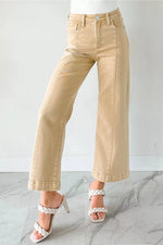Beige pants worn by a person on a marble floor with a white background