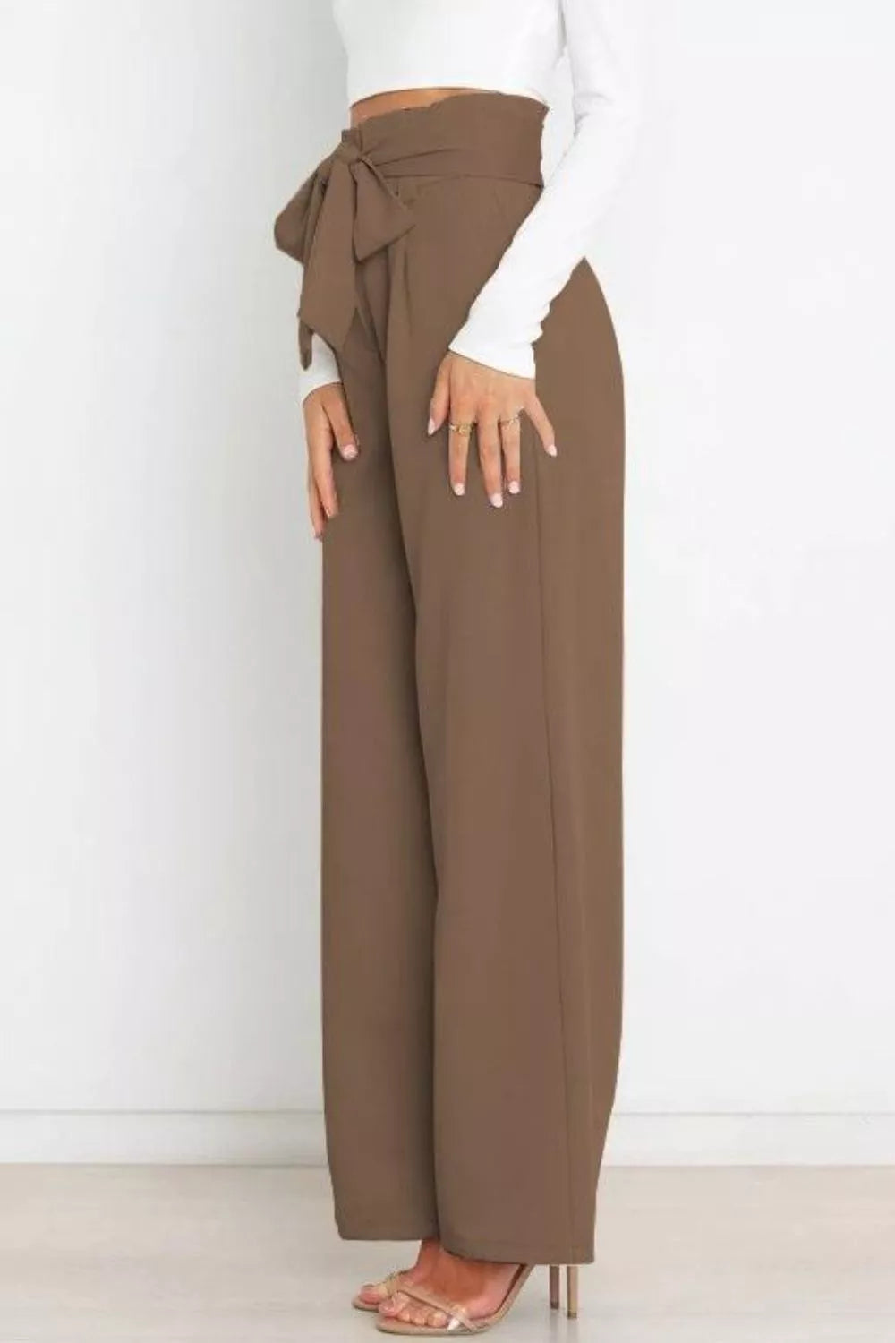 Brown wide-leg pants with a tie waist worn by a person on a white background