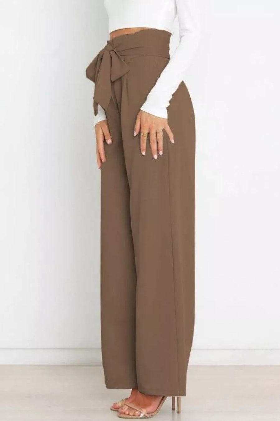 Brown wide-leg pants with a tie waist worn by a person on a white background