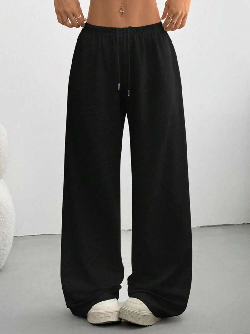 Black wide-leg pants worn by a person on a plain background