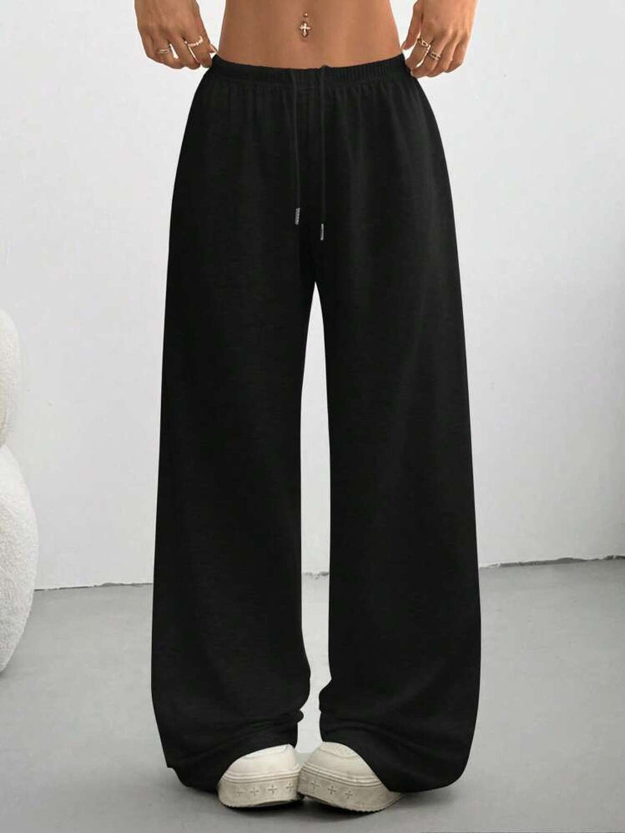 Black wide-leg pants worn by a person on a plain background