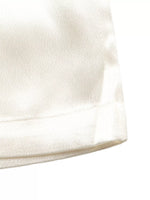 Close-up of a textured white fabric surface