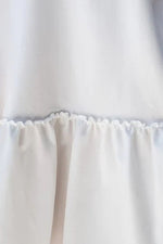 view of the hem on white Ruffle Hem Round Neck Short Sleeve Mini Dress