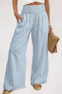 Person wearing blue and white striped pants on a plain background
