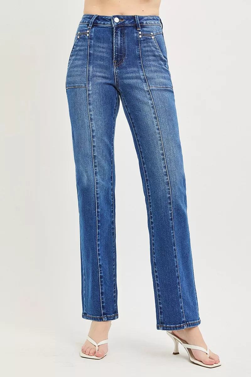 Blue jeans worn by a person on a light gray background