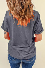 Person wearing a gray t-shirt and blue jeans with a neutral background
