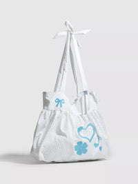 White bag with blue designs on a light gray background