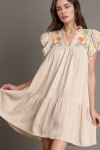 Full view of woman in a beige dress