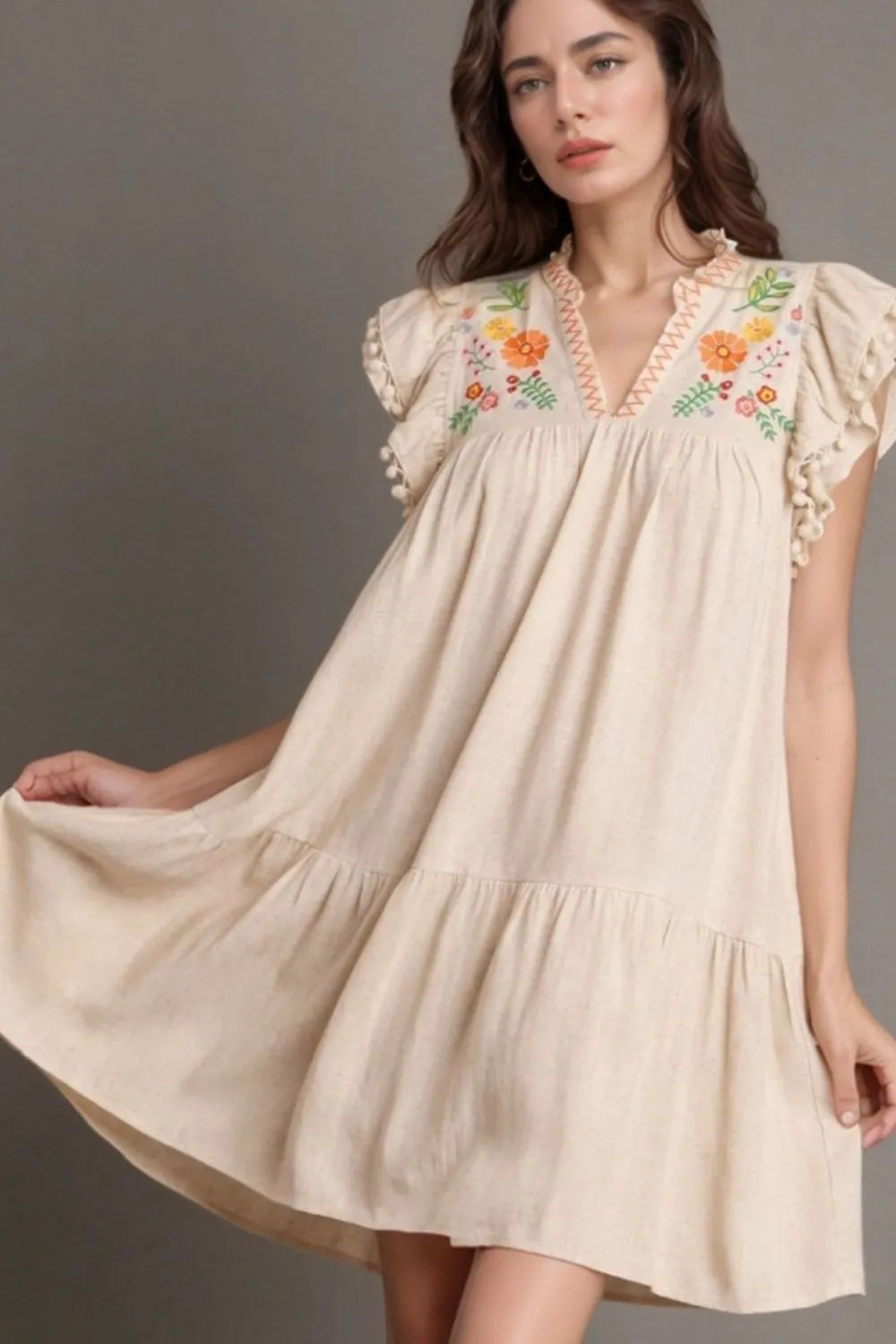 Full view of woman in a beige dress