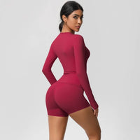 Person wearing a maroon athletic outfit on a plain background