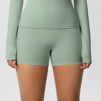 Person wearing a green athletic outfit on a plain background