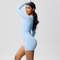 Woman wearing a light blue dress against a gray background