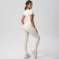 Woman wearing a white outfit on a plain background