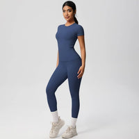 Woman wearing a blue athletic outfit on a white background