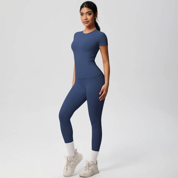 Woman wearing a blue athletic outfit on a white background