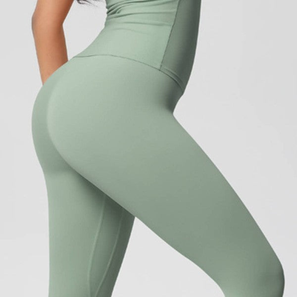 Green leggings worn by a person on a light gray background