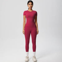 Woman wearing a pink athletic outfit on a white background