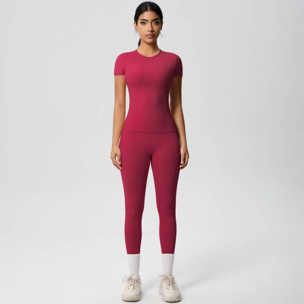 Woman wearing a pink athletic outfit on a white background