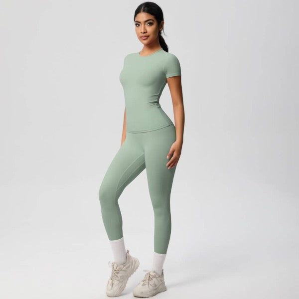 Woman wearing a green athletic outfit on a white background