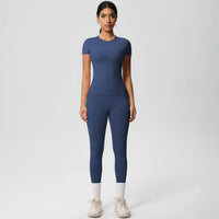 Woman wearing a blue athletic outfit on a white background