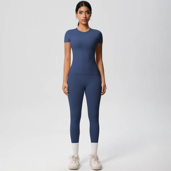 Woman wearing a blue athletic outfit on a white background