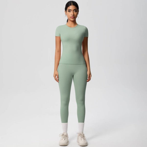 Woman wearing a green athletic outfit on a white background