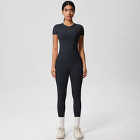 Woman wearing a black athletic outfit on a white background