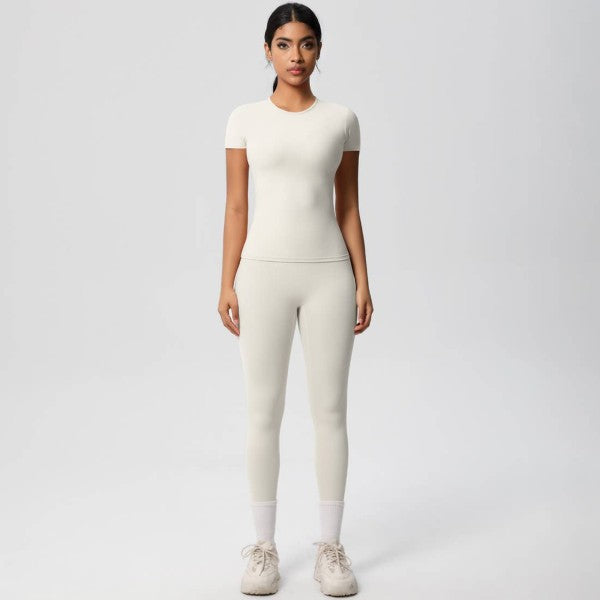 Woman wearing a white outfit on a plain background