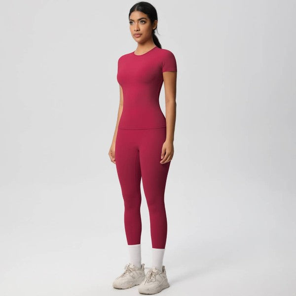Woman wearing a pink athletic outfit on a white background