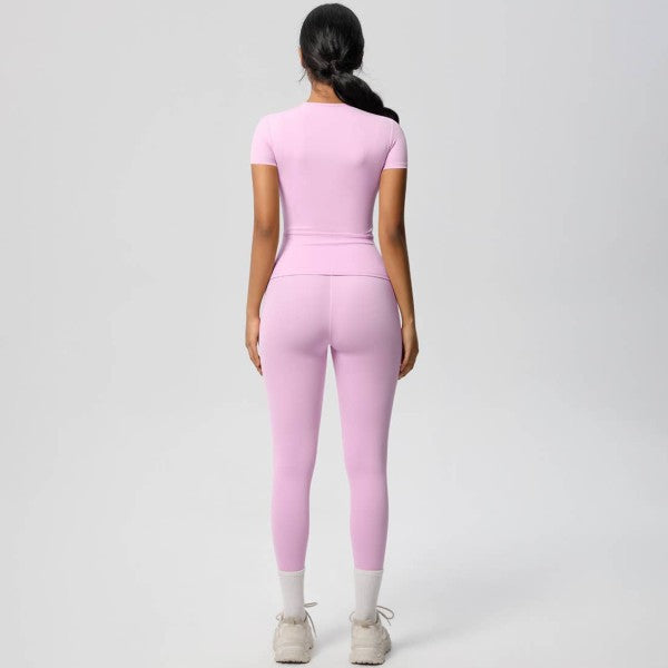 Person wearing a pink matching outfit on a gray background